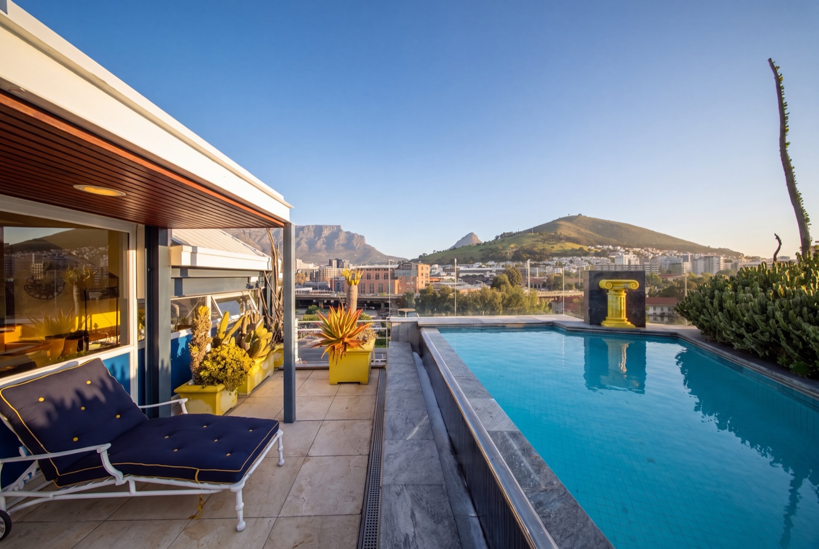 The rooftop pool of the Waterfront Penthouse, Table Mountain across the water