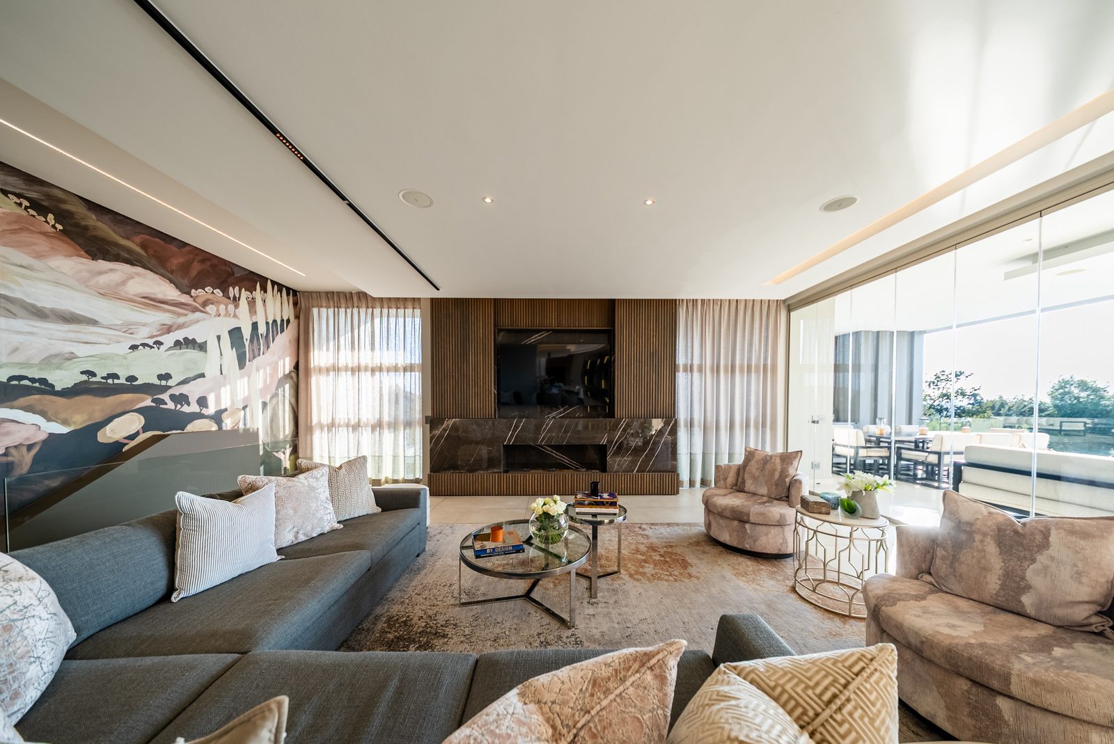Family lounge with media wall and commissioned mural