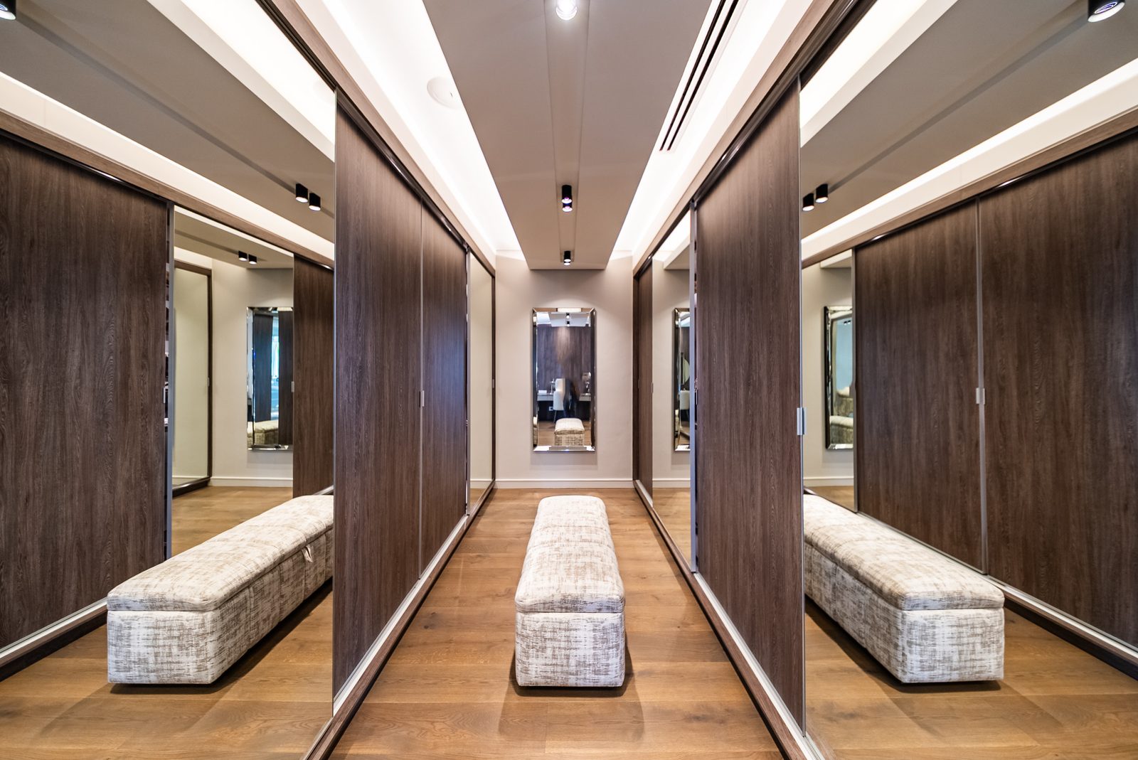 The principal dressing room, mirrored wardrobes down both sides