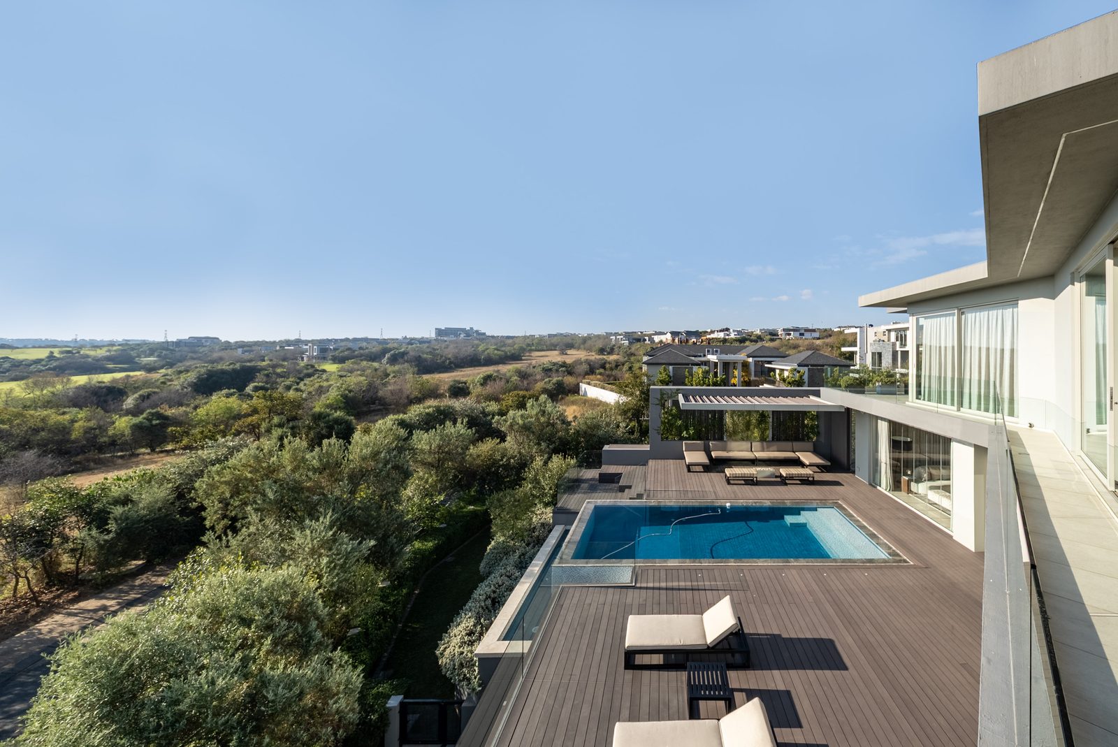 View from the balcony over the pool deck toward the Steyn City parkland