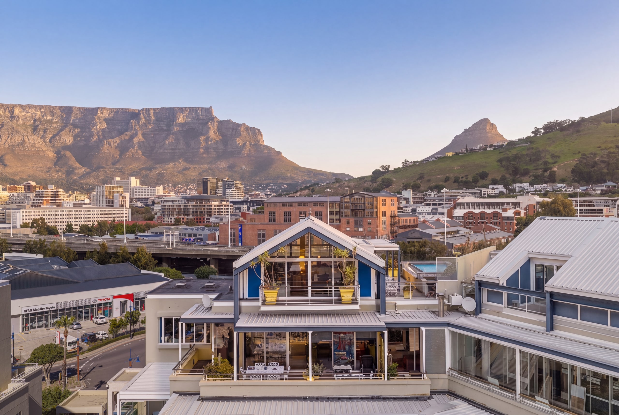 An aerial view of the Waterfront Penthouse above the V&A Marina, with Table Mountain, Lion's Head and Signal Hill beyond