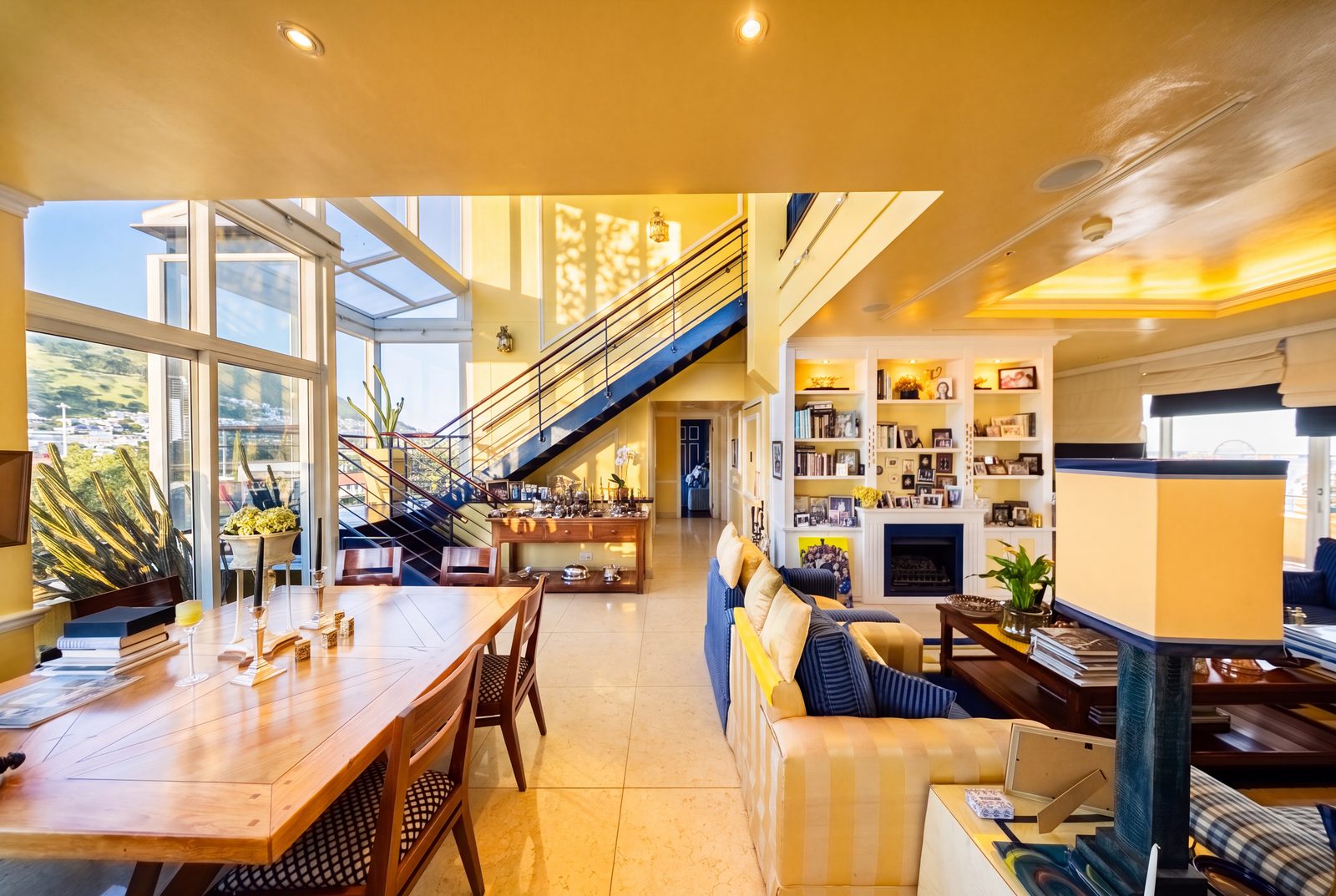 The double volume living hall, its staircase rising over the marble floor