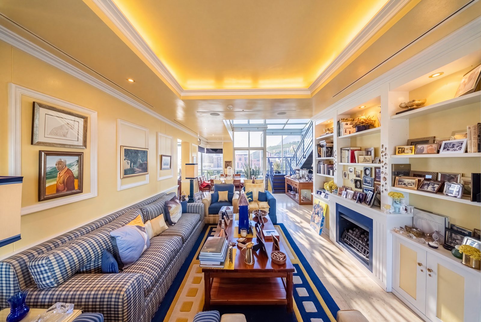 The family lounge, gas fireplace and full bookshelves