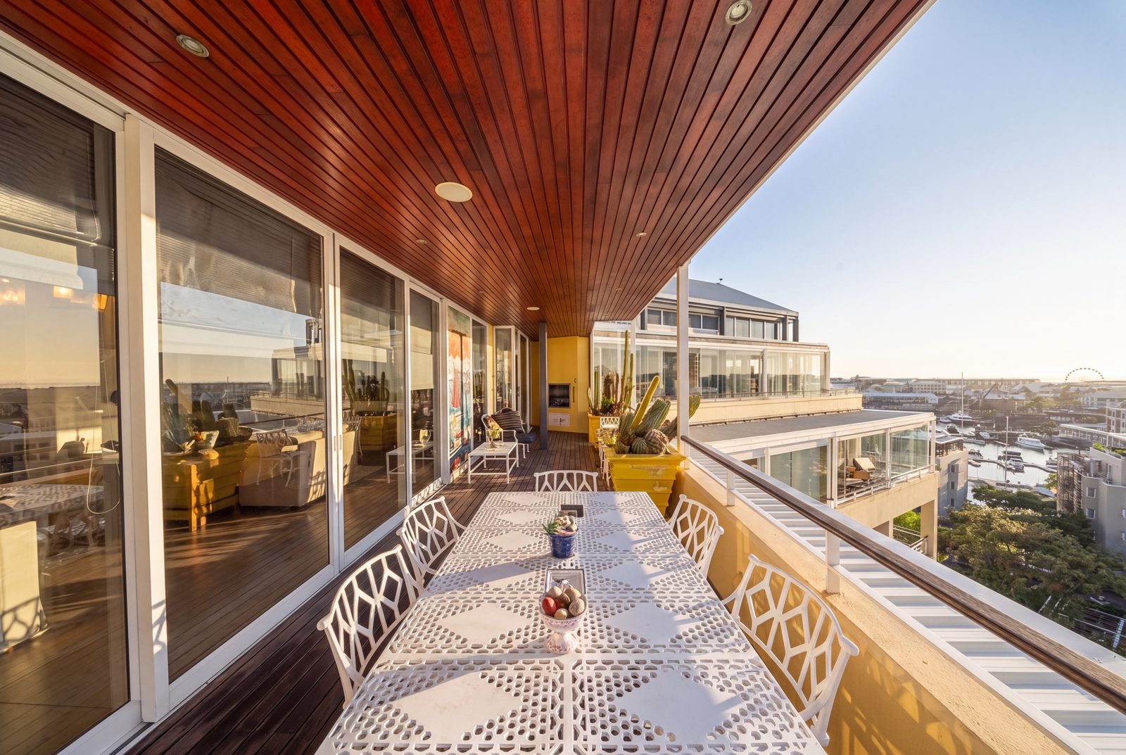 The balcony along the glazed facade, the marina and the Cape Wheel beyond
