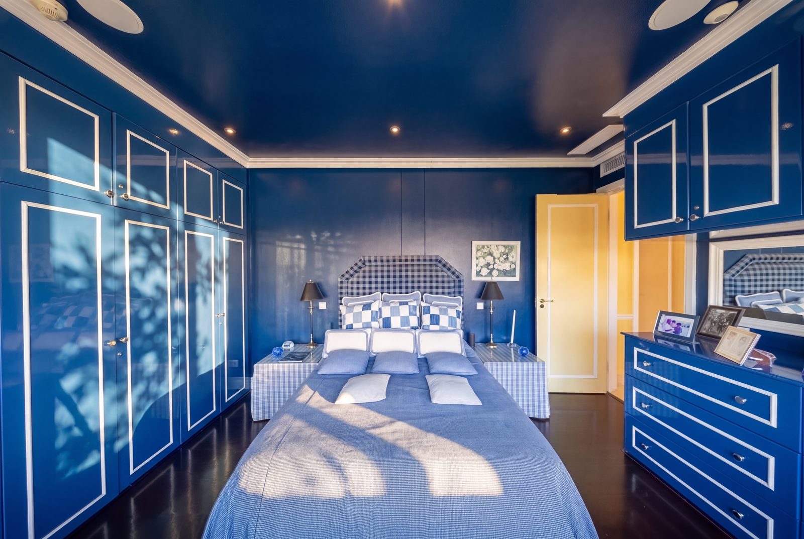 The second bedroom's lacquered wardrobes and dresser