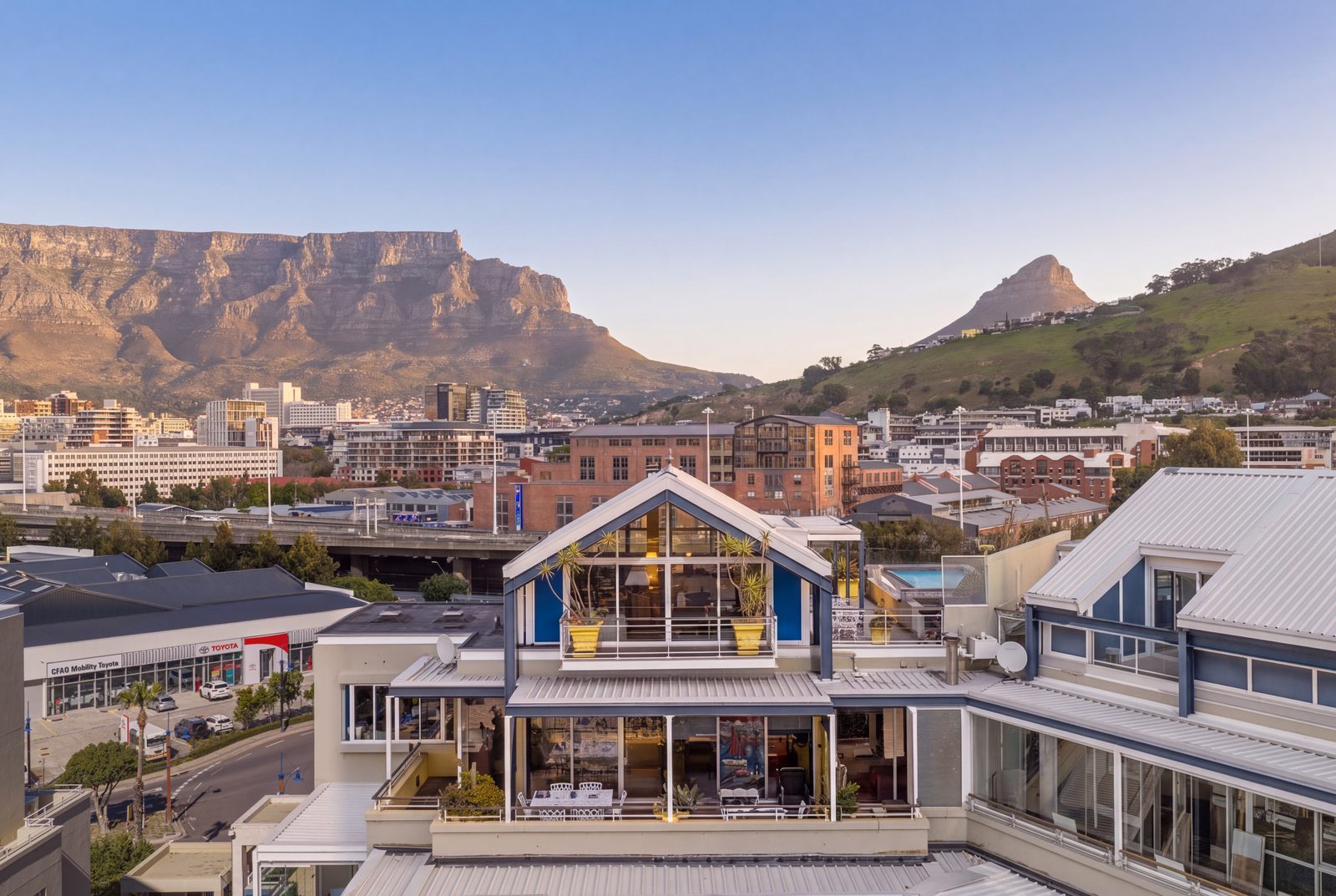 The penthouse against Table Mountain and Lion's Head, golden hour over the rooftop pool