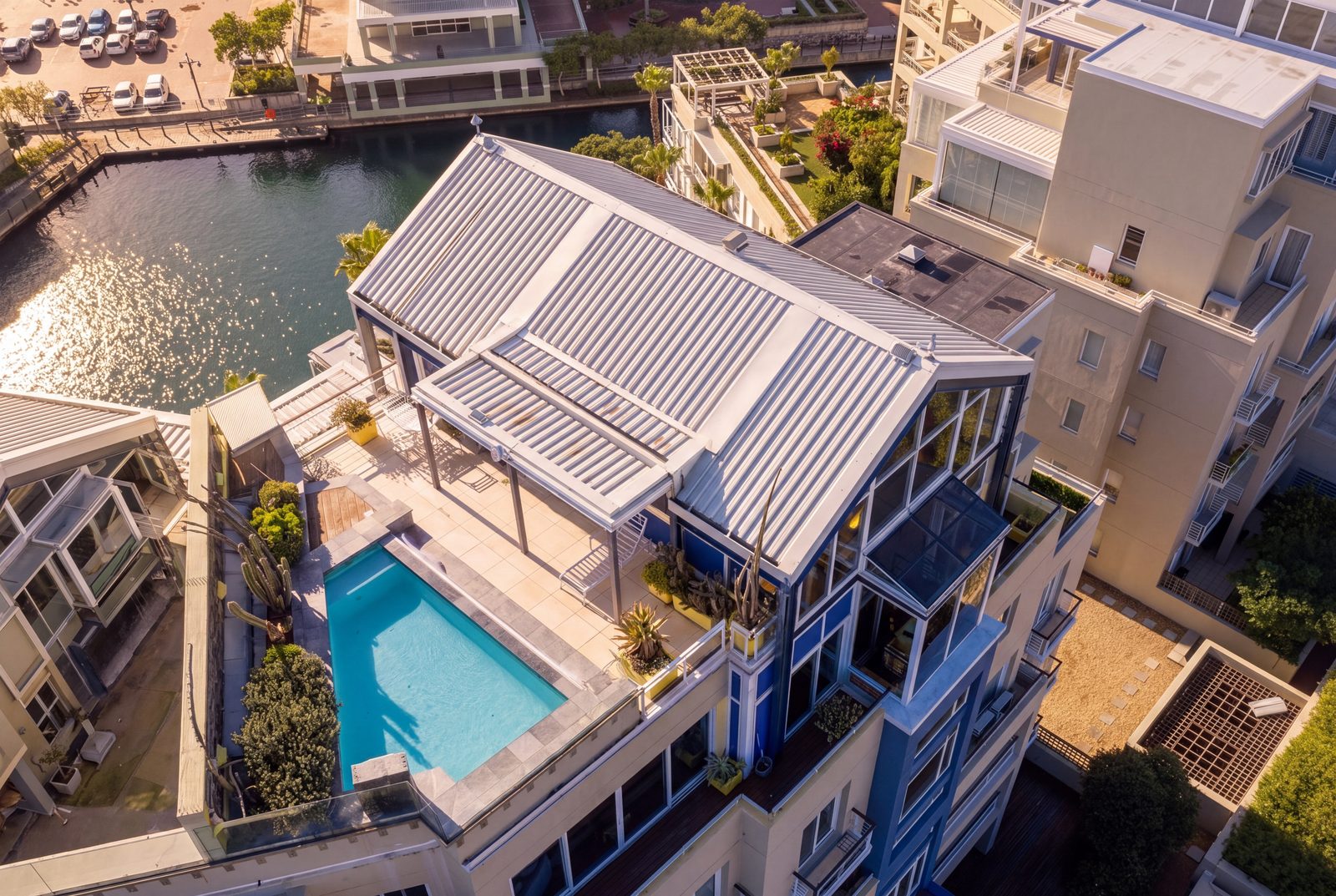 The twin gables and rooftop pool from directly above, the marina at the door